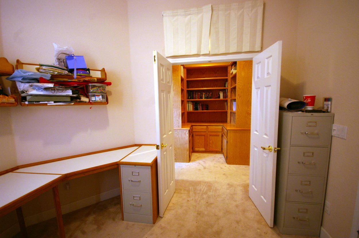 View out study door - with file cabinets in view - of bookshelves